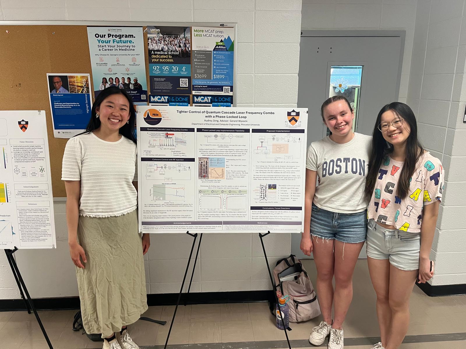 three girls standing next to a research poster